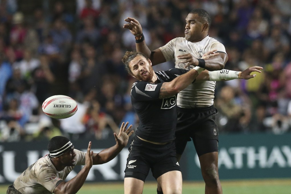 Isake Katonibau (right) makes his presence felt against New Zealand in the final of the 2016 Cathay Pacific/HSBC Hong Kong Sevens. Fiji won 21-7, their fourth victory in a row. Photo: K. Y. Cheng