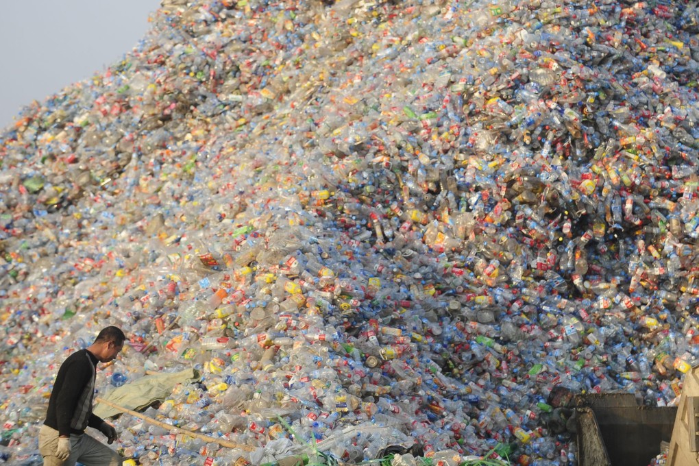 Chinese workers unload used plastic bottles for recycling at a plastic material factory in Wuhan, in this 2010 file photo. Photo: AFP