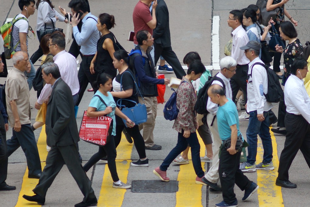 People cross a street in Central, the city’s central business district, on May 16 of 2017. Photo: Fung Chang