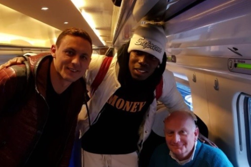 Manchester United’s Nemanja Matic, Paul Pogba and Nate Patrick's father on a train from Manchester. Photo: Twitter