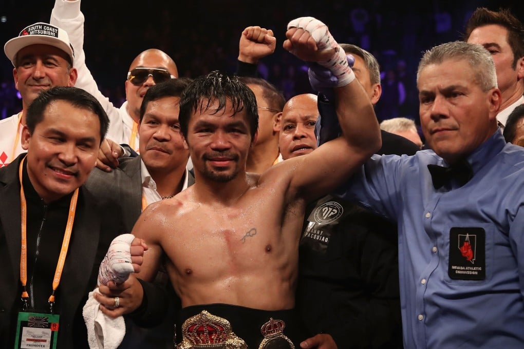 Manny Pacquiao celebrates after defeating Adrien Broner by unanimous decision the at MGM Grand Garden Arena. While he way away in Las Vegas, his house was reportedly burgled. Photo: AFP