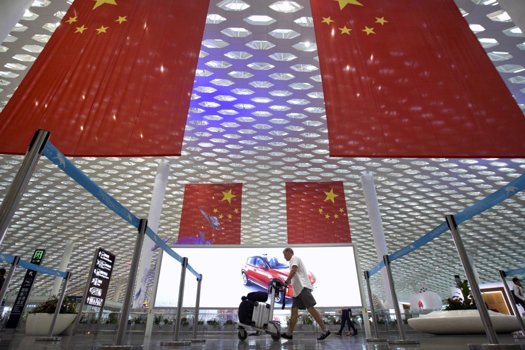 Gigantic Chinese flags hang from the ceiling at Shenzhen International Airport. Photo: AP
