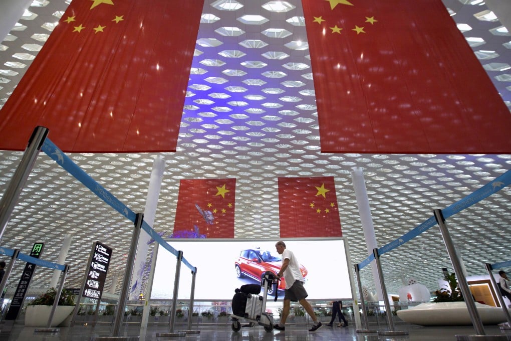 Gigantic Chinese flags hang from the ceiling at Shenzhen International Airport. Photo: AP