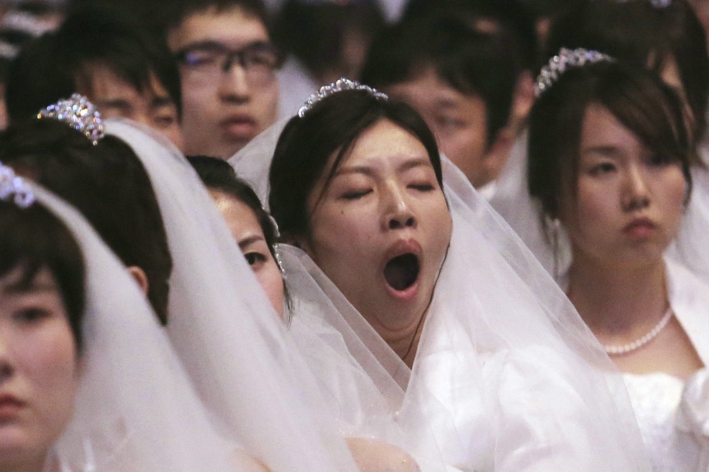 A bride yawns during a mass wedding held in Gapyeong, South Korea, in August. Photo: AP