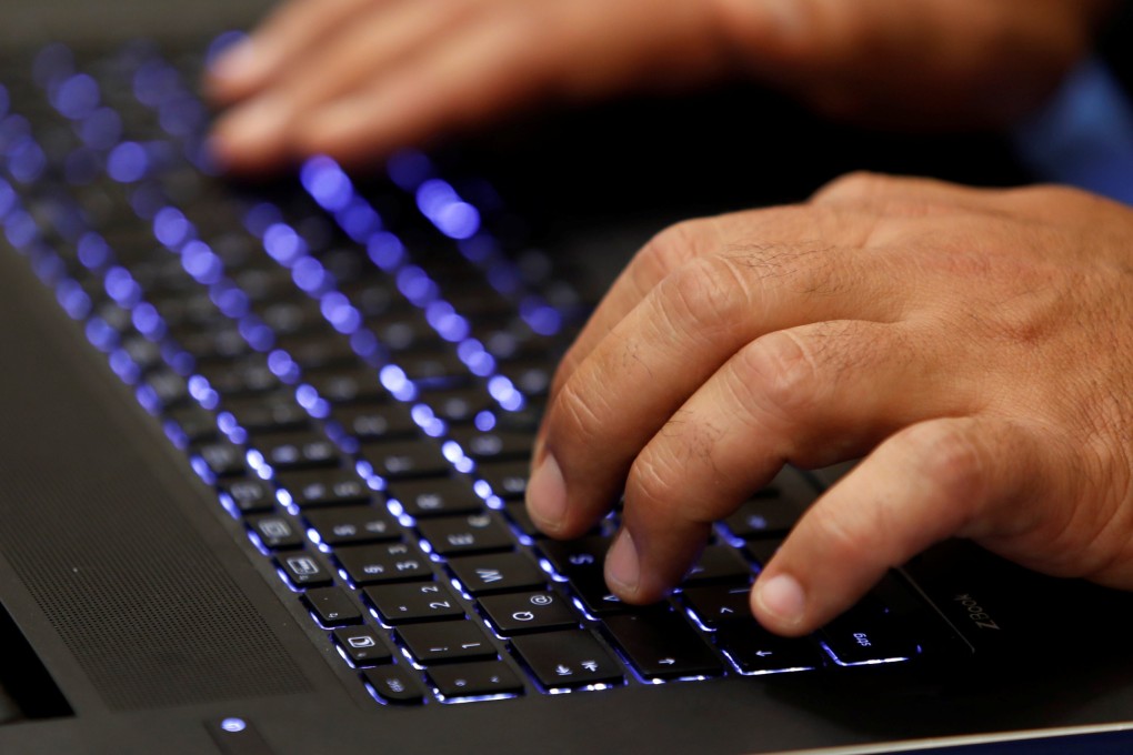 A person types on a computer keyboard. The UK’s internet watchdog has found a record number of websites with illicit material depicting children being abused. Photo: Reuters