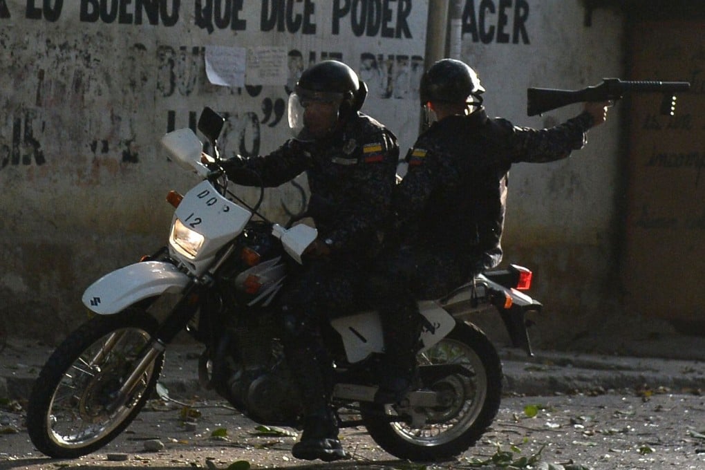 Riot policemen on a motorcycle during clashes with anti-government demonstrators in Caracas, on January 21, when a group of soldiers rose up against Venezuela's President Nicolas Maduro. Photo: AFP
