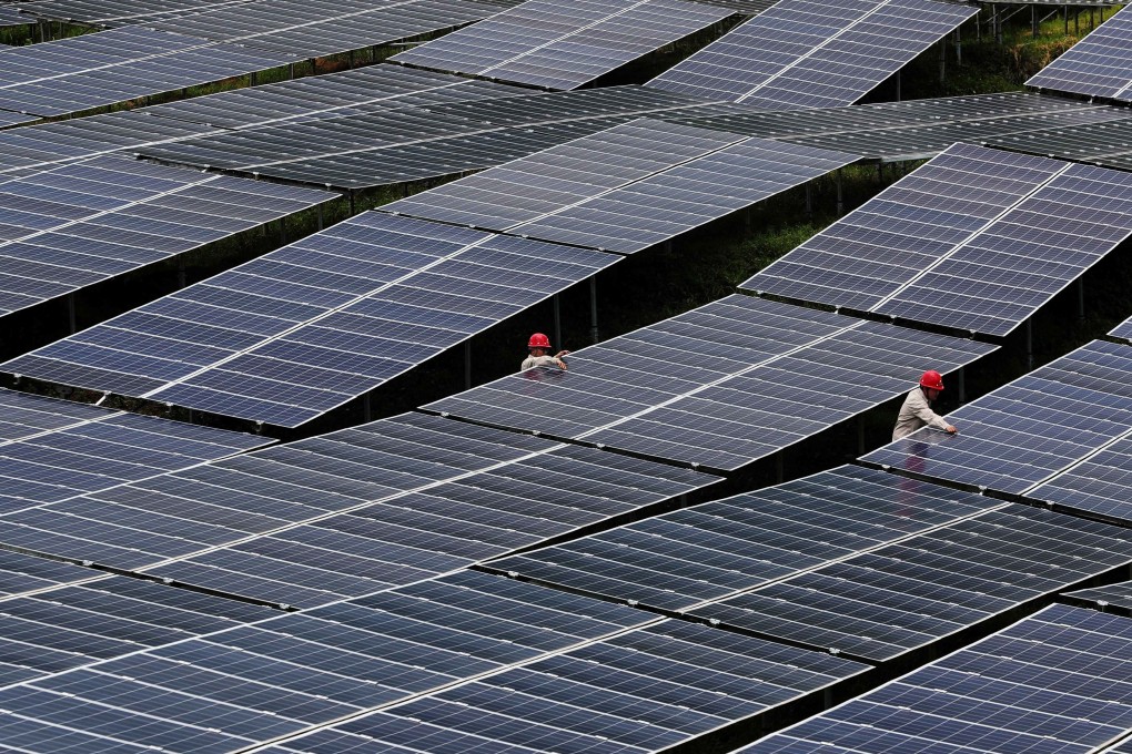 Workers check solar panels at a photovoltaic power station in Chongqing, China, in July 2018. The country installed 53GW of solar power in 2017. Photo: Reuters