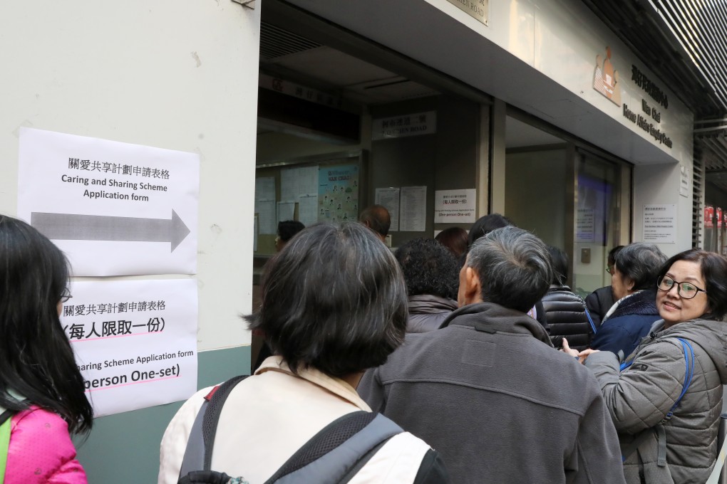 People queue up to collect an application form for the scheme at the Wan Chai Home Affairs Inquiry Centre. Photo: K.Y. Cheng