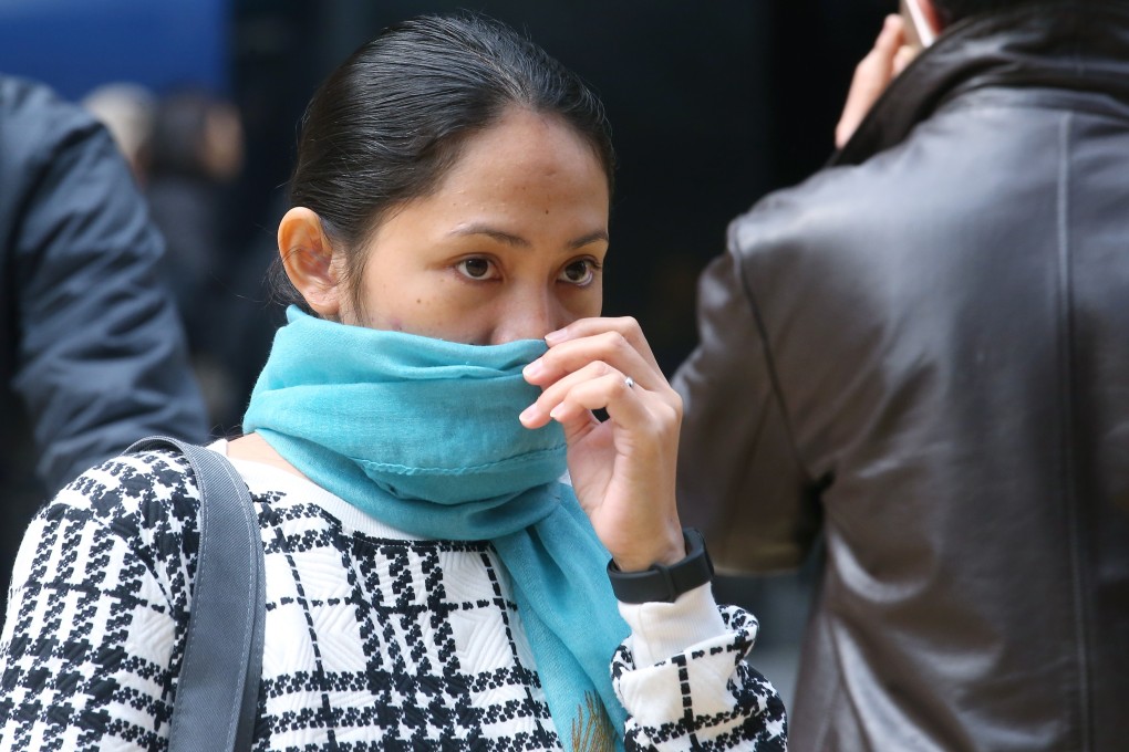 A woman in Central wears a scarf in the cold weather. Photo: David Wong