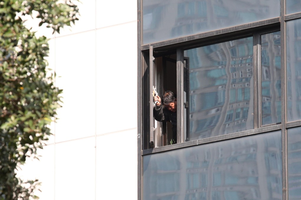 A worker checks a window at the hotel on Tuesday. Photo: Felix Wong/SCMP