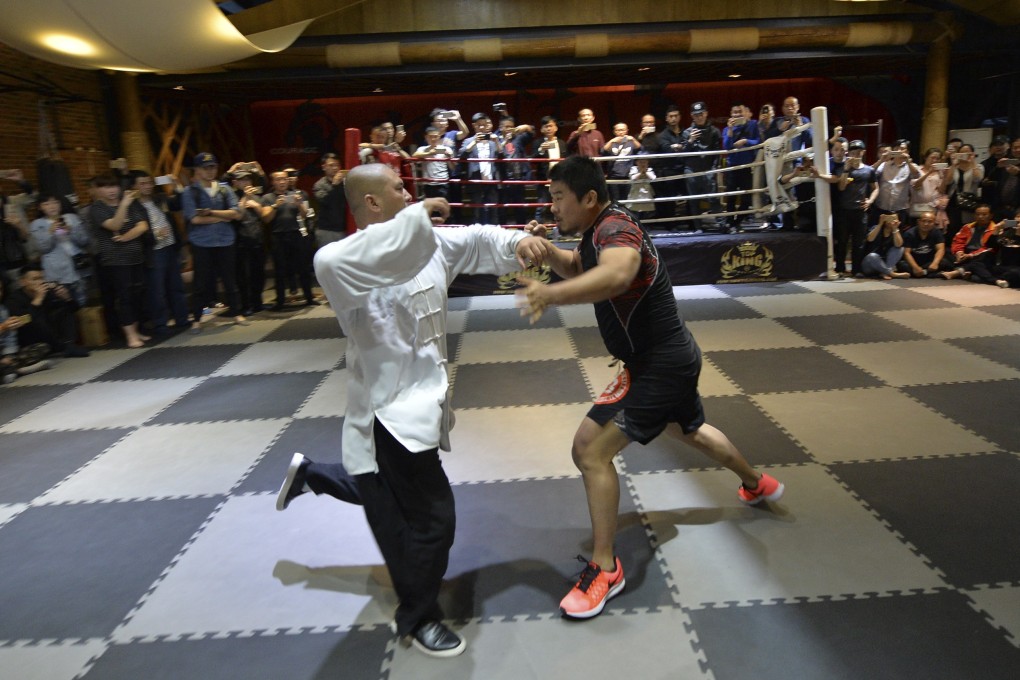 Chinese tai chi “master” Wei Lei (left) competes against retired mixed martial arts boxer Xu Xiaodong in Chengdu. Photo: Imaginechina