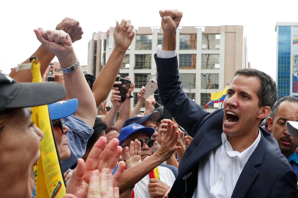 Juan Guaido, the president of Venezuela's National Assembly, greets supporters during a rally in Caracas on Wednesday where he declared himself the country’s interim president. Photo: Reuters