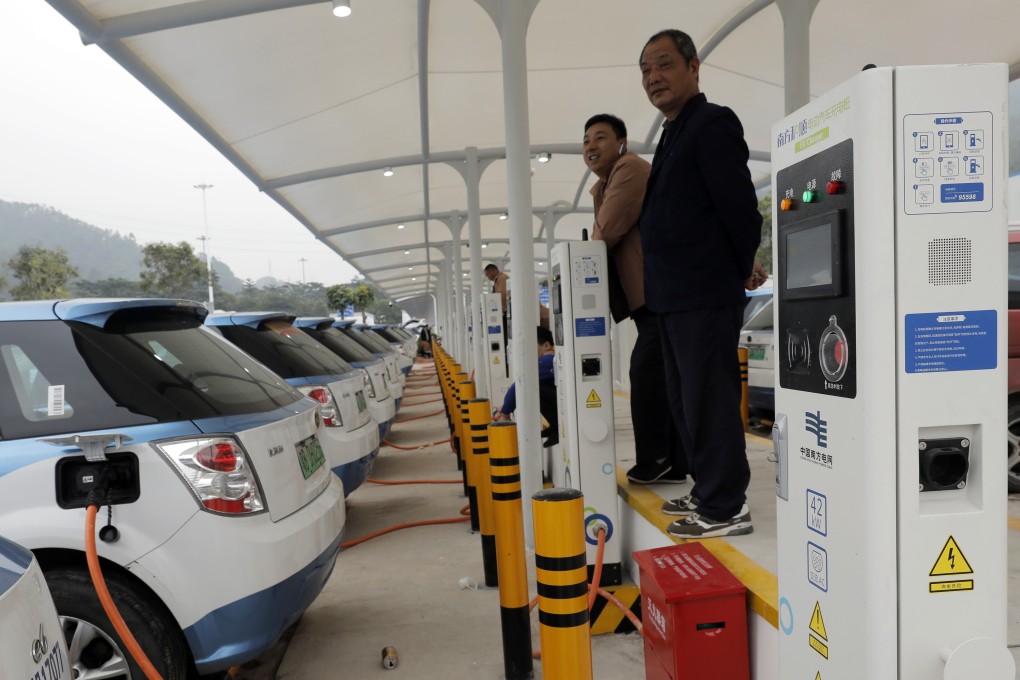New electric taxis at a public charging station in Shenzhen, south China. Photo: AP