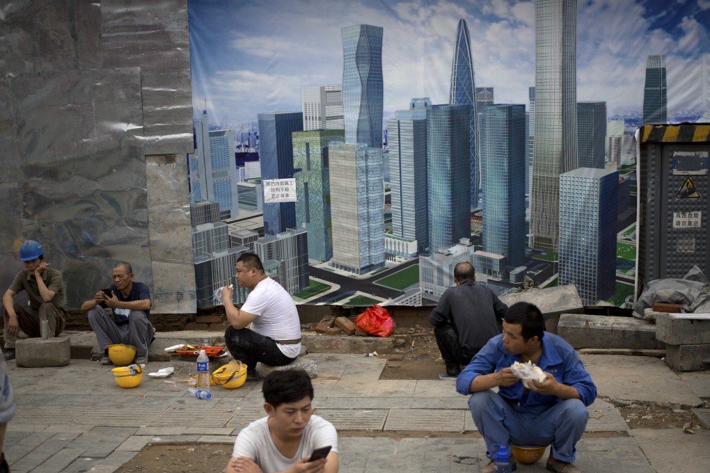 Construction workers take their lunch break outside a construction site in Beijing. Photo: AP