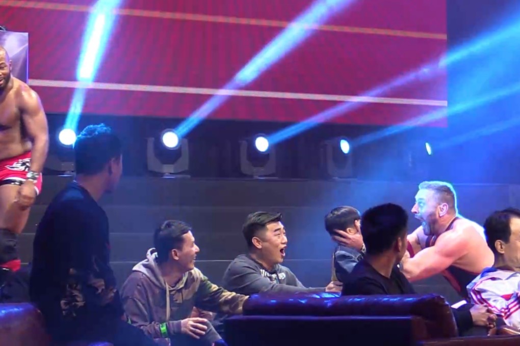 Colt Cabana celebrates with a young fan after winning his match with tag team partner Jay Lethal at Extreme Wrestling Entertainment in Macau. Photo: Nicolas Atkin