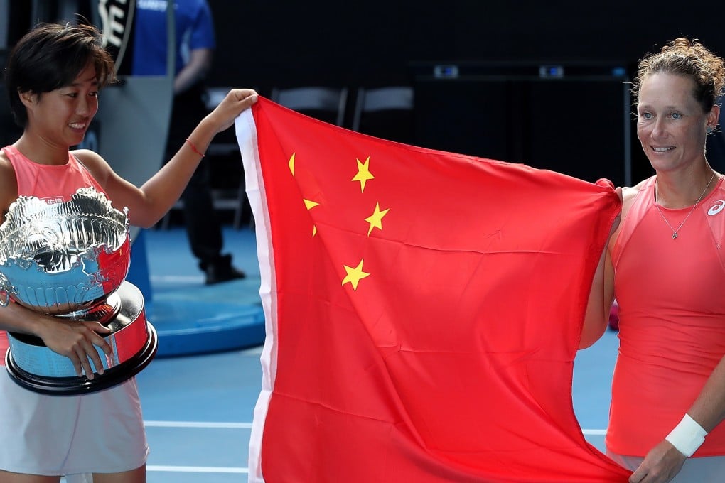 Zhang Shuai and Samantha Stosur hold the Chinese flag after defeating Timea Babos and Kristina Mladenovic in the women’s doubles final at the Australian Open. Photo: EPA