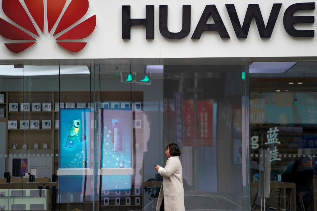 A woman walks by a Huawei logo at a shopping centre in Shanghai in December. The telecoms giant is facing increasing restrictions in countries allied with the US. Photo: Reuters