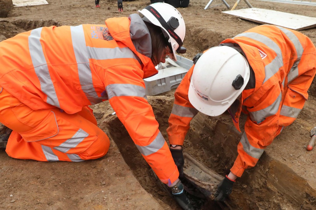 Archaeologists removing the coffin plate of Royal Navy captain Matthew Flinders, during the excavation and research works at St James's Gardens near Euston train station in London. Photo: AFP