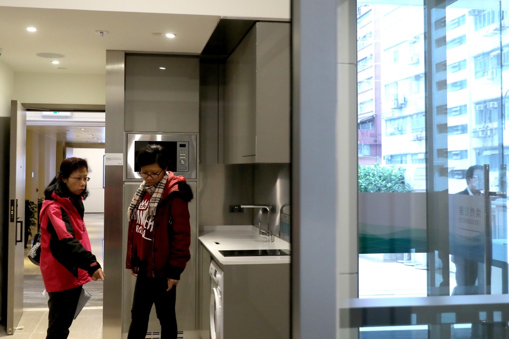 Potential buyers inspect the eResidence show flat for the Housing Authority’s starter homes project. Photo: Sam Tsang