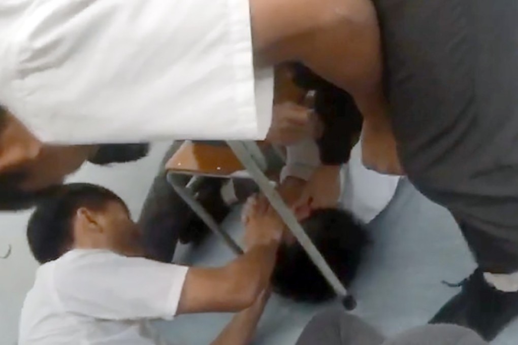 A 39-second video posted on Facebook showed a male student in school uniform being pinned down between two chairs by about seven other students. Photo: Handout