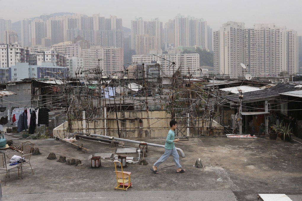 A child walks among illegal rooftop cubicle homes in Kwun Tong, in March 2017. Hong Kong’s poor need monetary help, but also need to help themselves. Photo: Dickson Lee