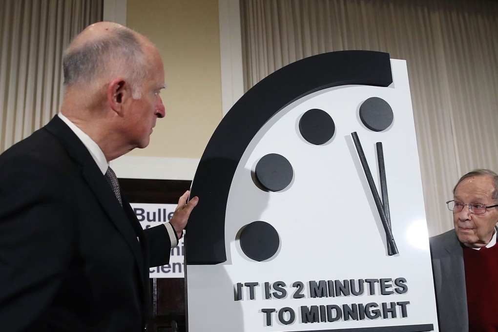 Former California Governor Jerry Brown, left, and former US Secretary of Defence William Perry unveil the Doomsday Clock during The Bulletin of the Atomic Scientists news conference on Thursday in Washington DC. Photo: AFP