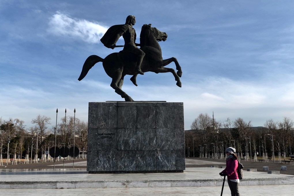 A woman passes next to the statue of Alexander the Great in Thessaloniki, Greece on January 24, 2019. Photo: AFP