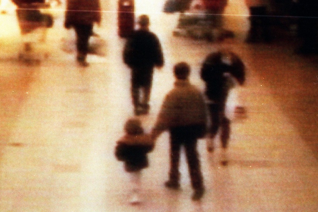 A 1993 file video still of James Bulger, aged two (front left) being led away in a shopping centre in the Bootle area of Liverpool. Photo: AP