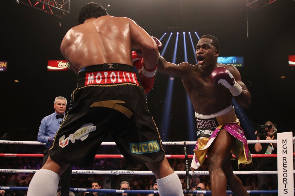 Adrien Broner throws a right at Manny Pacquiao. Photo: AFP