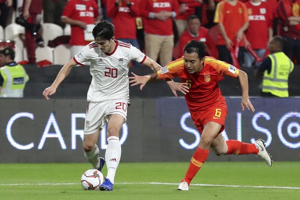 Feng Xiaoting (right of China vies with Sardar Azmoun of Iran during the AFC Asian Cup. Photo: Xinhua