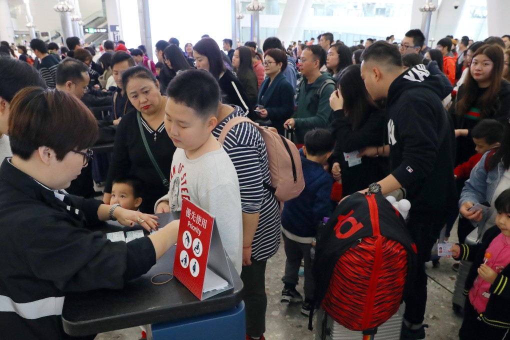 Security staff manually check passengers tickets inside the West Kowloon station. Photo: Edmond So