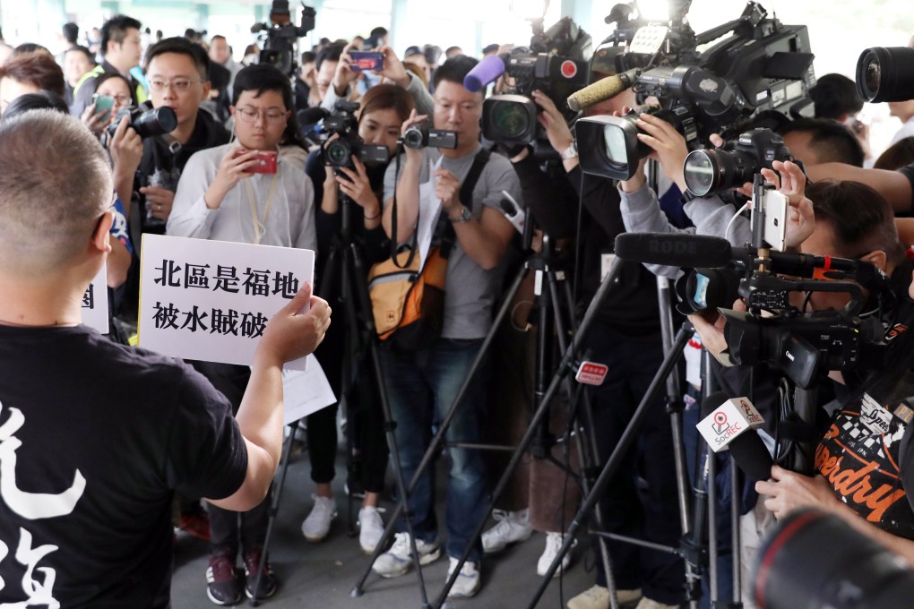 Protesters on a footbridge outside Sheung Shui MTR station. Photo: Nora Tam