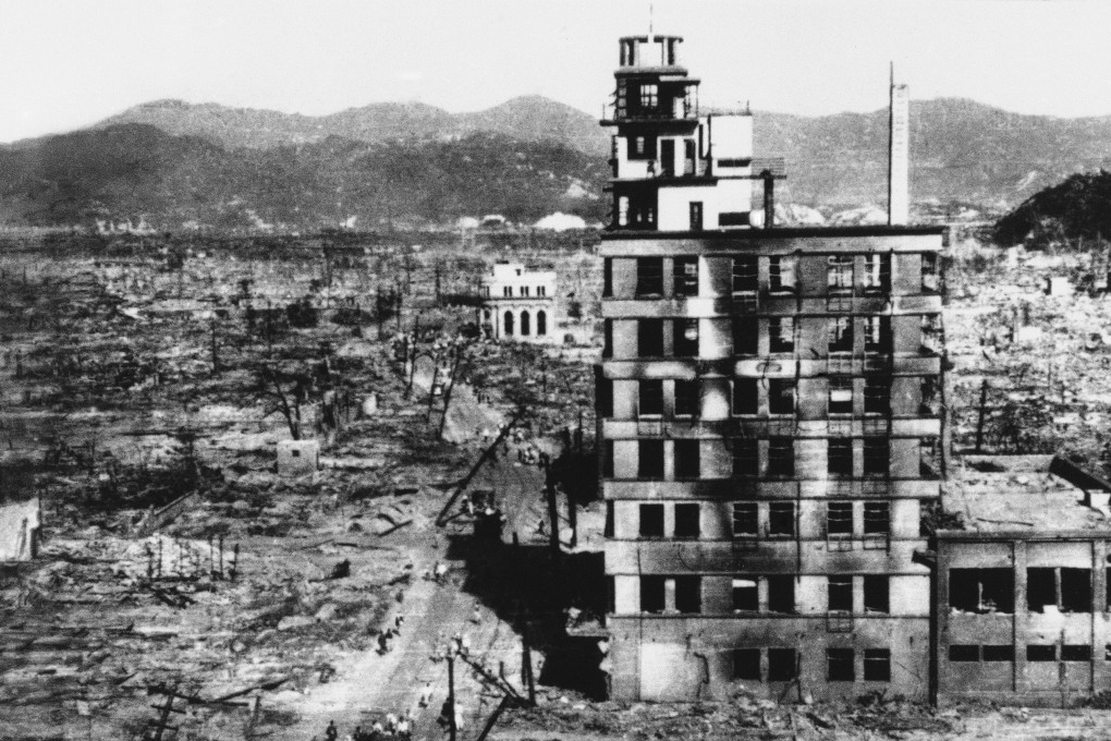 An August 8, 1945 photo of survivors walking past one of the few buildings still standing after the US nuclear attack on Hiroshima, Japan. Photo: AP