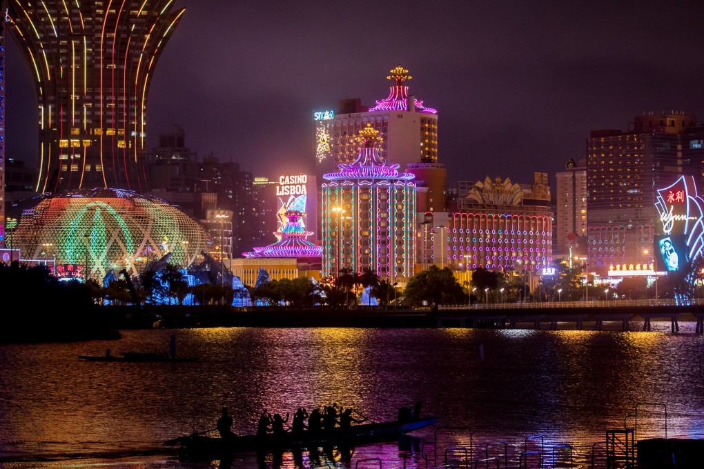 The Casino Grand Lisboa (left) and the Casino Lisboa, both operated by SJM Holdings, stand next to signage for the Wynn Macau casino in Macau on July 24, 2018. Photo: Bloomberg