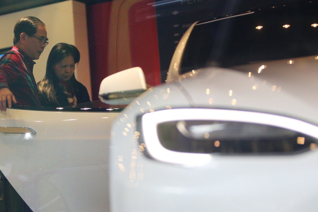 Potential buyers visit a Tesla showroom in Wan Chai. Photo: Dickson Lee