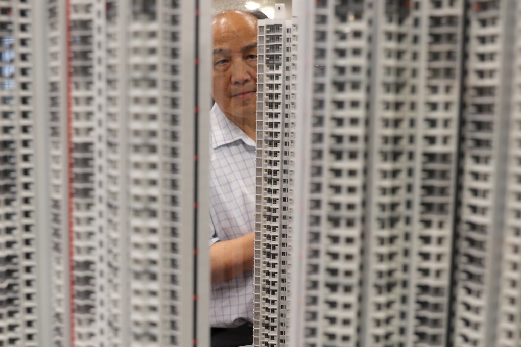 A man looks at housing models at the sale of Home Ownership Scheme flats at the Housing Authority headquarters in Lok Fu in September 2018. Between 2009 and the present, Hong Kong homes have become smaller and more unaffordable. Photo: Edward Wong