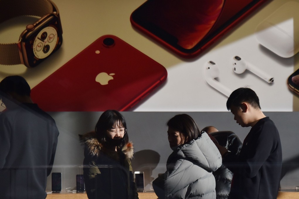 Customers look at products at an Apple store in Beijing. Reports say that iPhone sales fell in the fourth quarter on the mainland. Photo: AFP