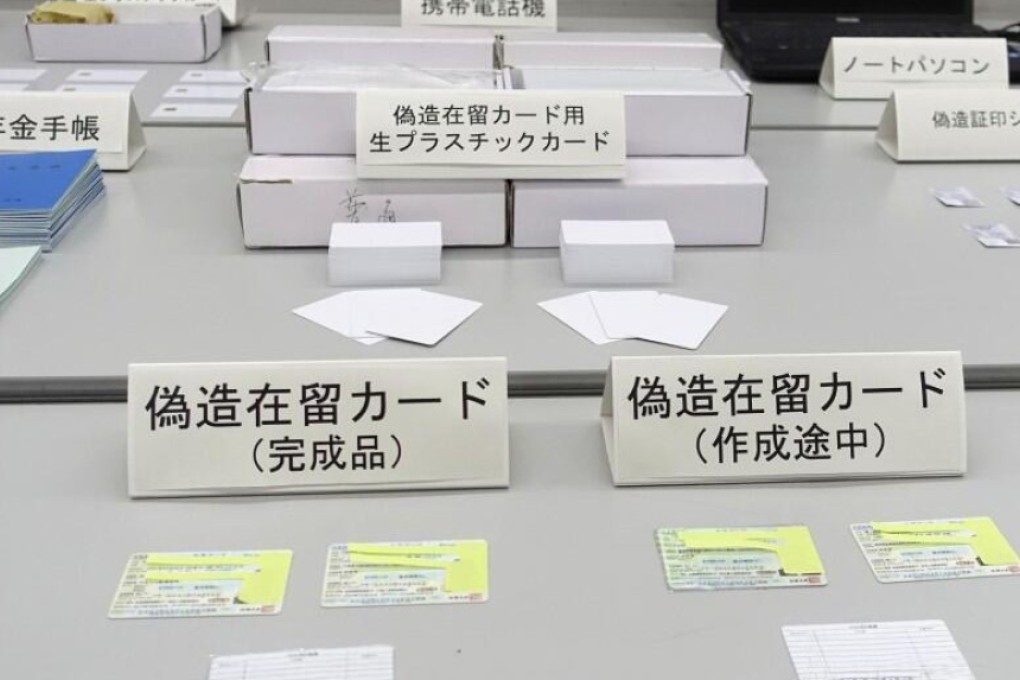 Japanese immigration officers confiscate 2,300 blank white cards which they believe were to be used to print fake permits for illegal workers. Photo: Sina
