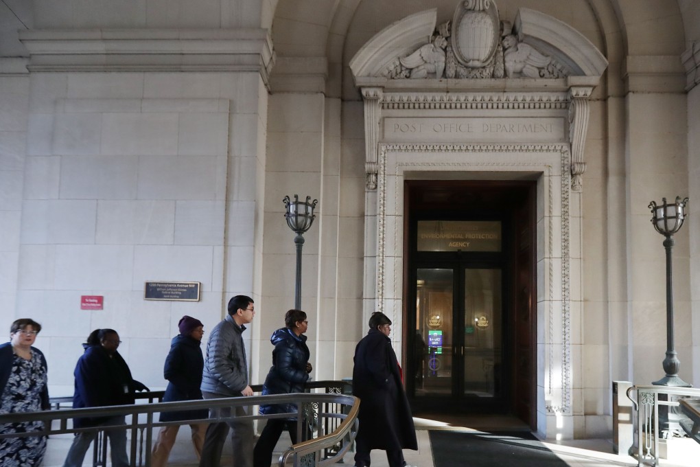 Federal employees returning to work at the Environmental Protection Agency headquarters on Monday in Washington. Photo: AFP
