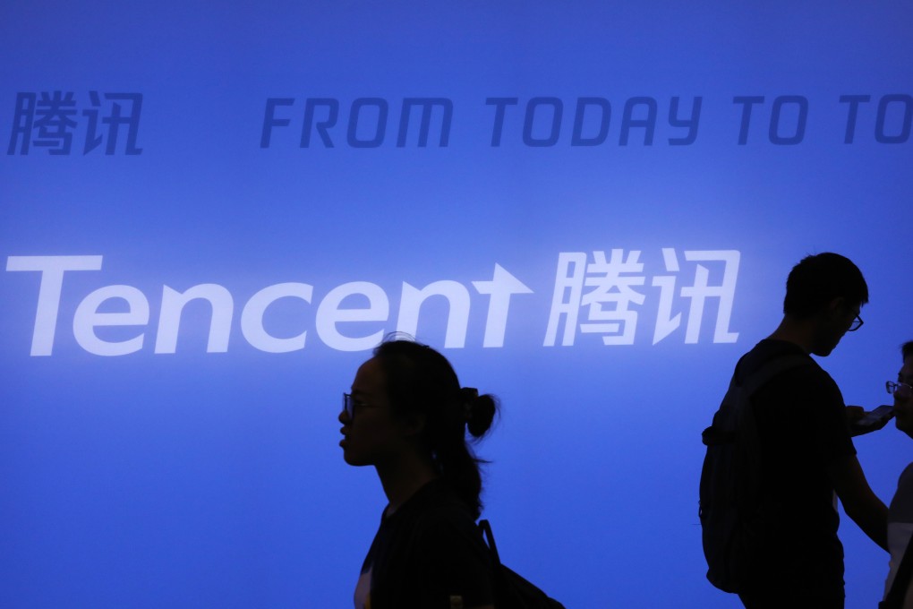 Visitors walk past the exhibition booth of Tencent Holdings during the 2018 Smart China Expo at the Chongqing International Expo Centre in the city of Chongqing in southwestern China. Photo: Simon Song