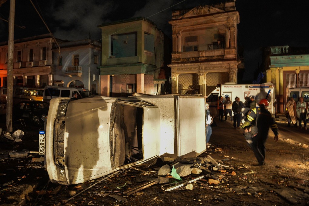 A damaged car lies on its side in the tornado-hit Luyano neighbourhood in Havana. Photo: AFP