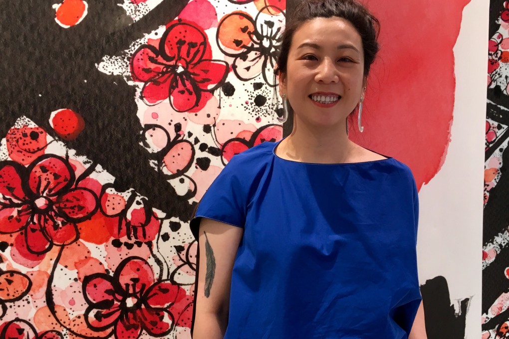 Ink-drawing artist Michell Lie with some of her work at the Lane Crawford department store in Central. She donates sale proceeds to a charity for the elderly. Photo: Kylie Knott