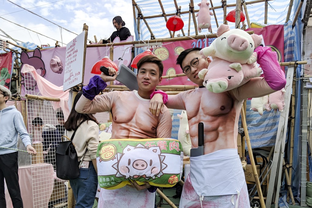Two university students dress up as butchers at the Victoria Park market. Photo: Sum Lok-kei