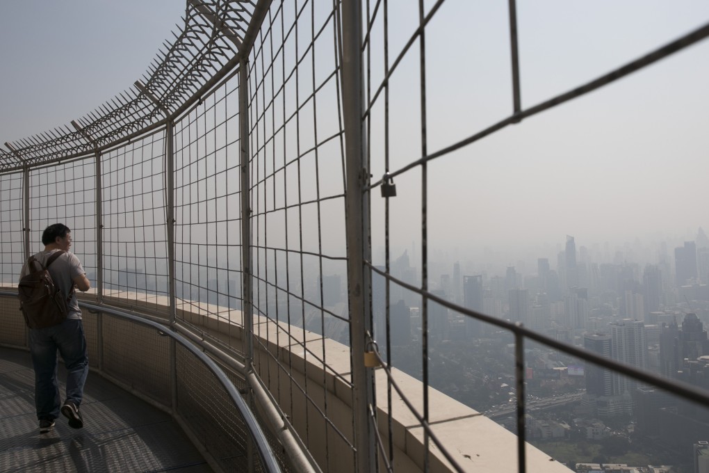 A tourist on the observation deck at Baiyoke Tower in Bangkok. Photo: Bloomberg