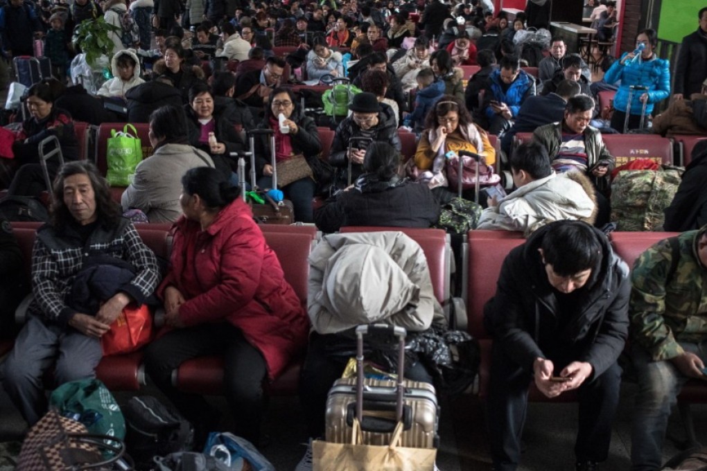 Passengers wait at Beijing Railway Station to catch their trains home ahead of Lunar New Year celebrations, on January 21. Picture: EPA