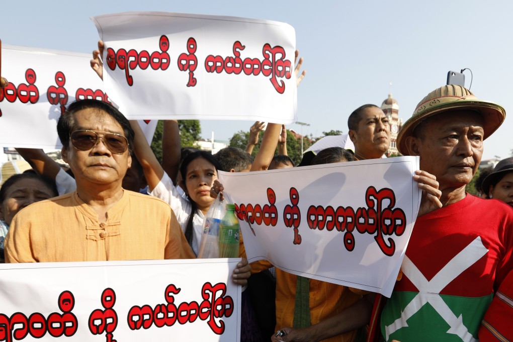 Protesters hold placards reading “Save the Irrawaddy” oppose the Myitsone dam project. Photo: EPA