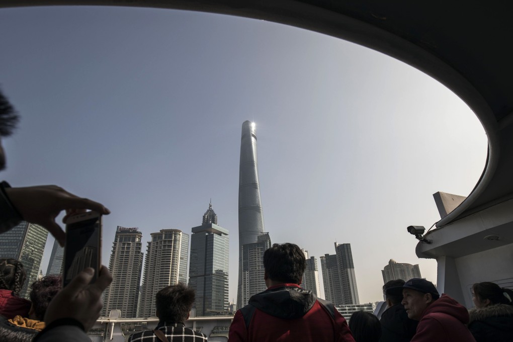 Tourists take a ferry across the Huangpu River in front of the Lujiazui Financial District in Shanghai. Finance is one sector of the Chinese economy that experts say needs to be opened up. Photo: Bloomberg