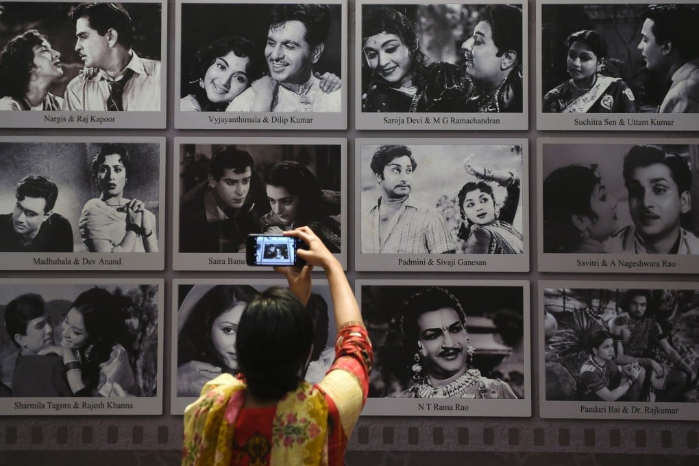 A visitor takes a picture of a display with images of former Indian movie actors at the National Museum of Indian Cinema. Photo: AFP