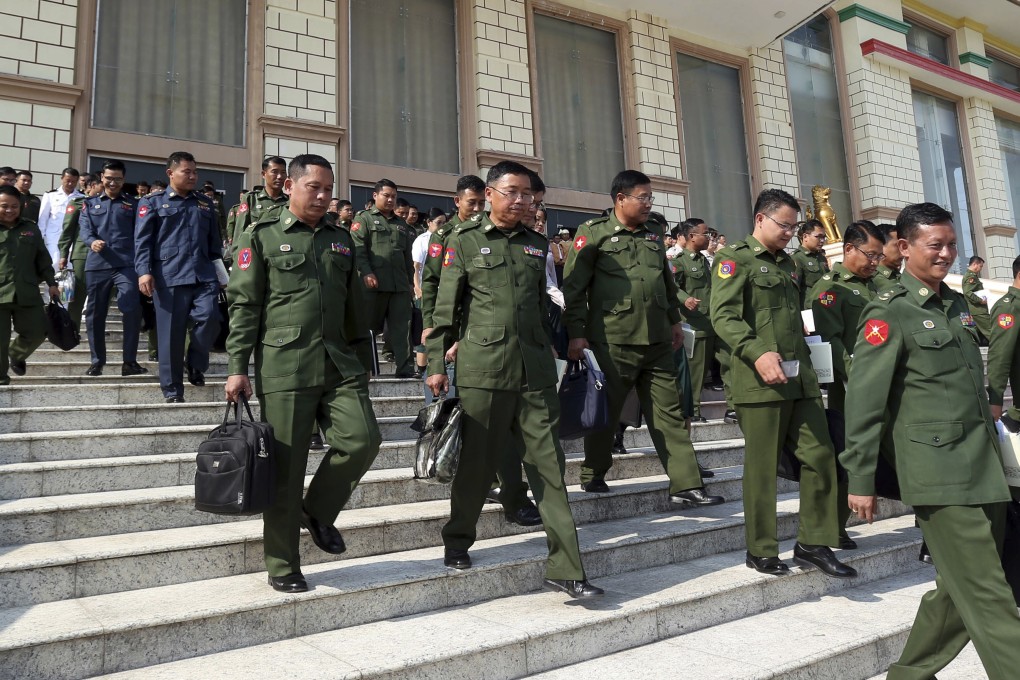 Myanmar’s military representatives leave following a regular session of the Union Parliament in Naypyidaw on Tuesday. Photo: AP