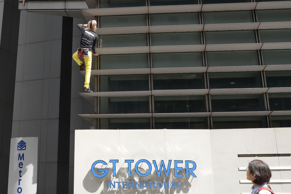 Alain Robert climbing the 47-storey GT Tower in Manila on Tuesday. Photo: AFP